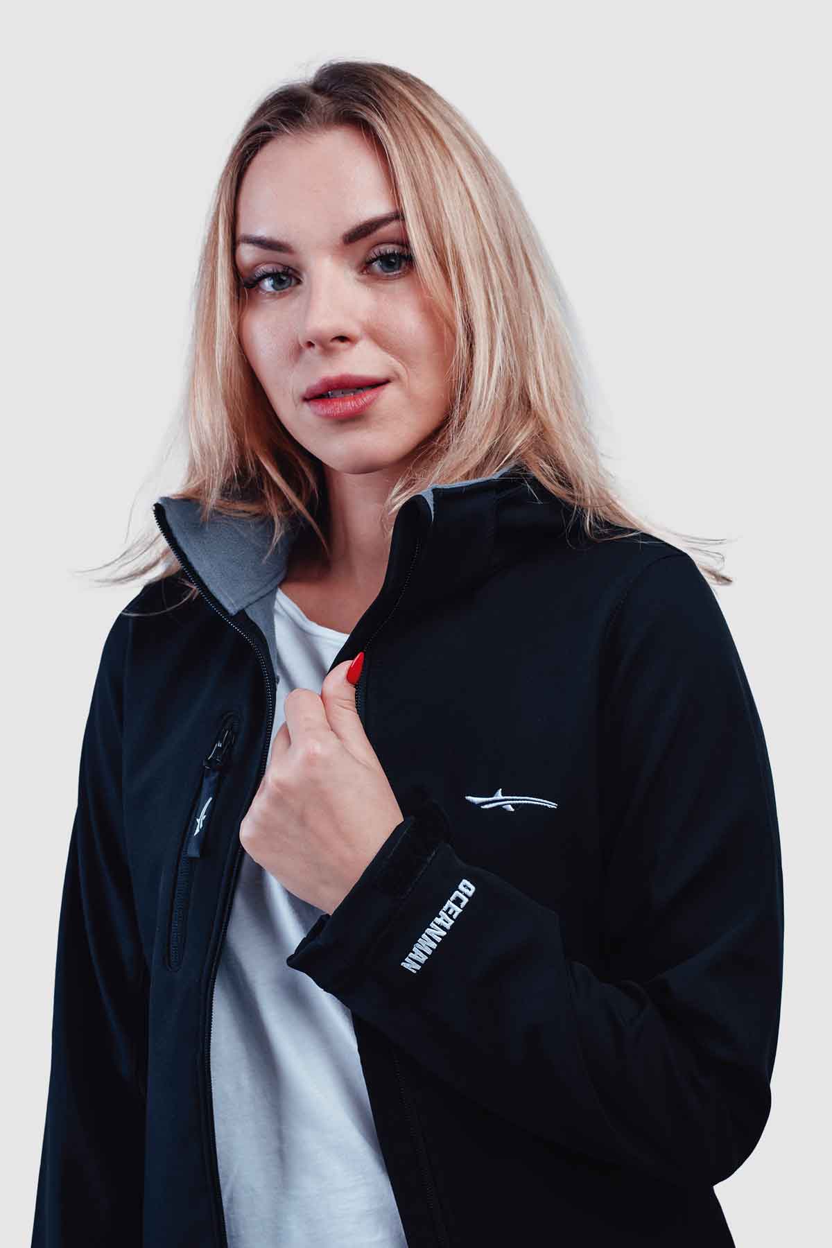 Woman wearing a black jacket with oceanman logo and details