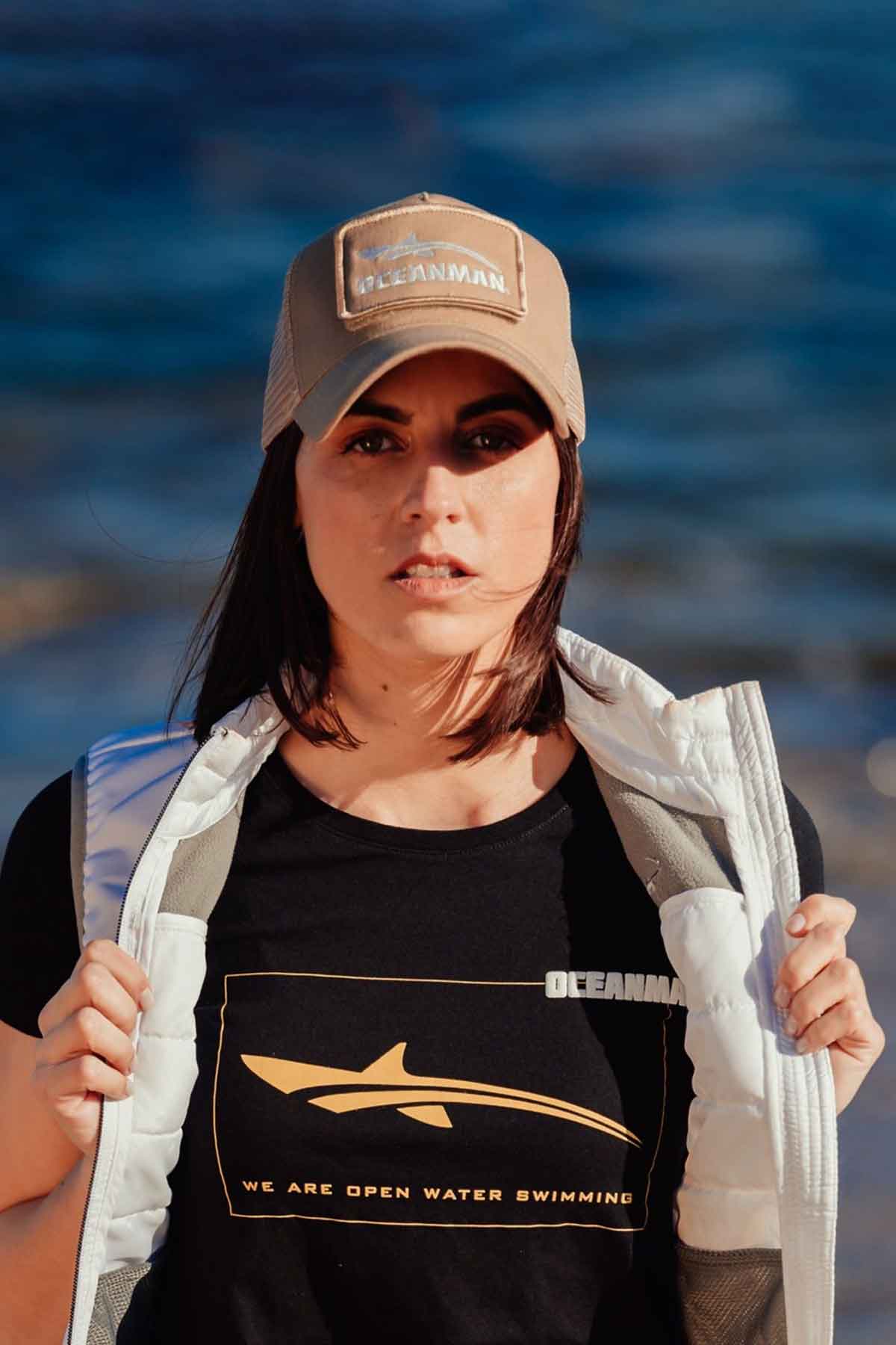 oceanwomen black t shirt at beach with vest